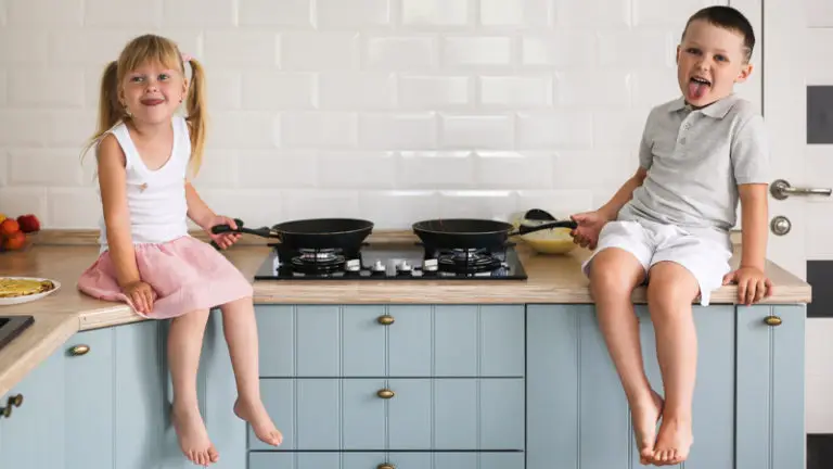 Kids sitting on kitchen counter