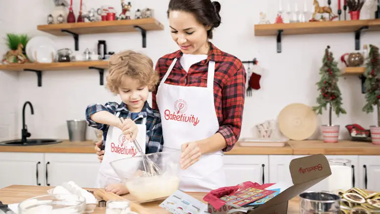 Mother and child baking with Baketivity hat and apron and baketivity subscription box