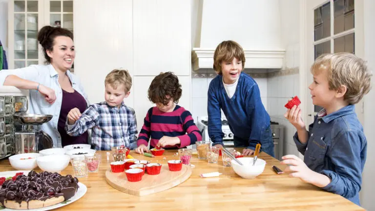 Family of boys baking together with mother