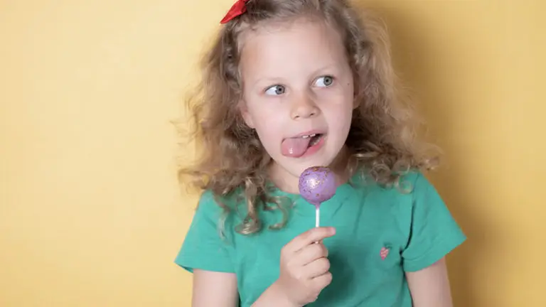 Cute girl licking a Cake Pop