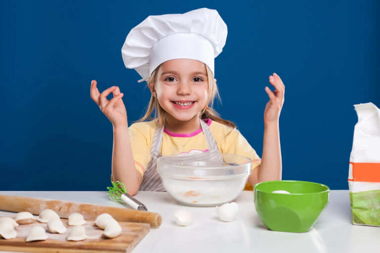 The little girl is cooking and preparing food