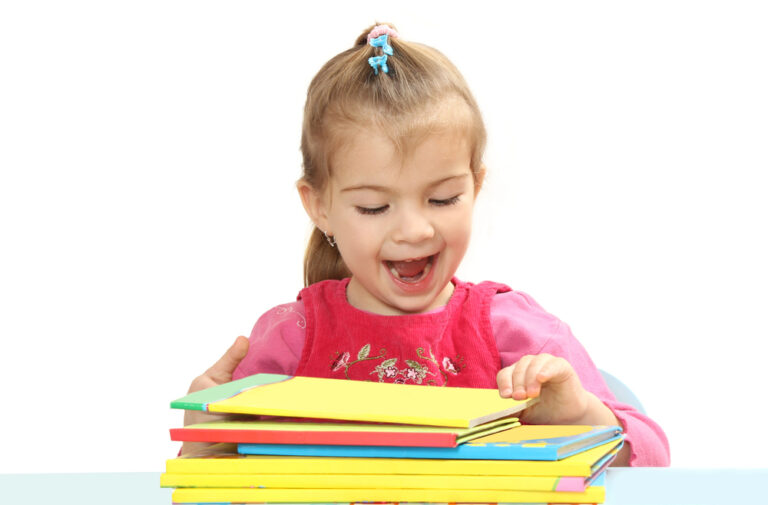 The little girl with books at a table