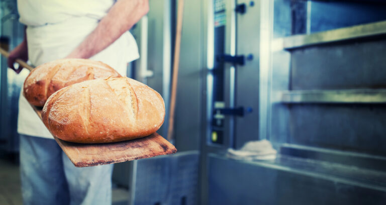 Baker in bakery with bread