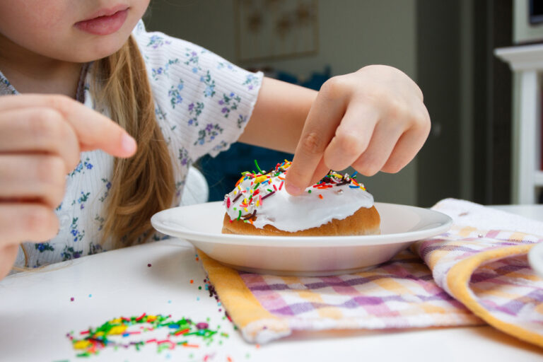 Process of decorating a cake with sweet colored decorations, concept of cooking of the Easter cake