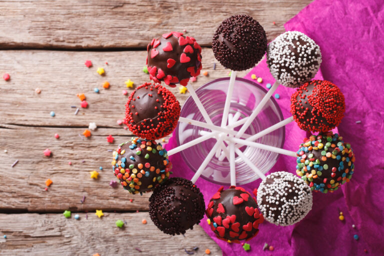 Delicious colorful cake pops in a glass