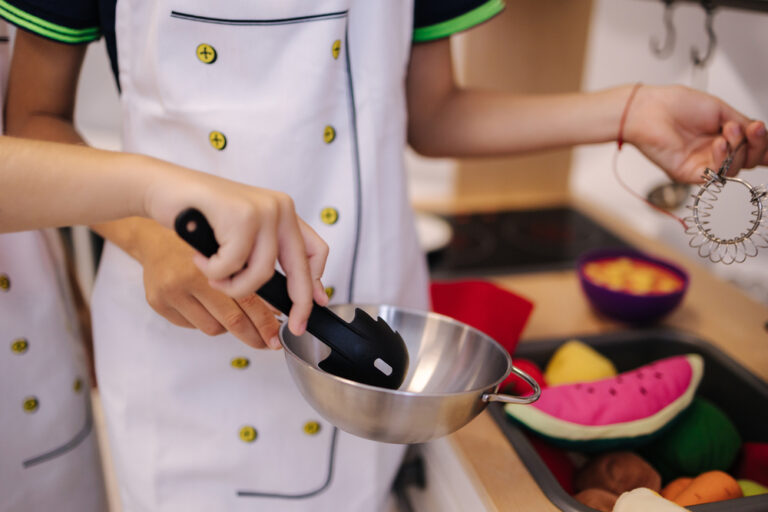 Close up of children play on toy kitchen. Cook a meal and play. Middle selection.