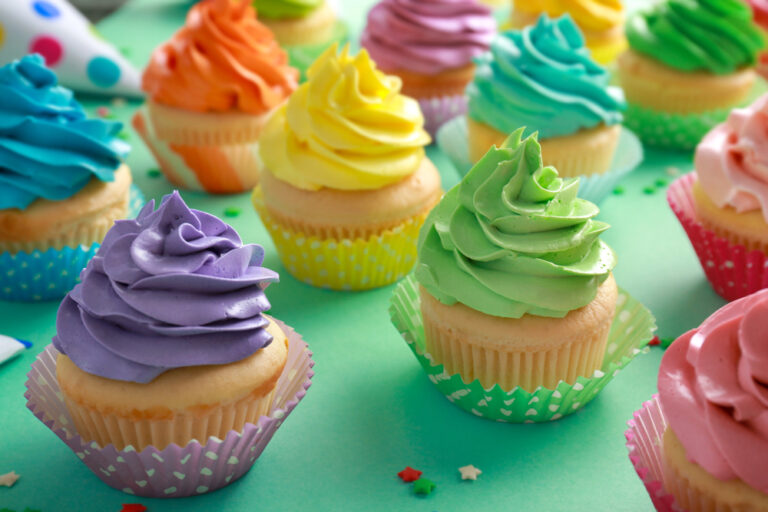 Tasty cupcakes on color background