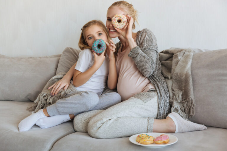 pregnant mom and her daughter on a sofa