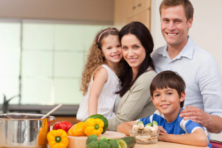 Smiling family standing in the kitchen