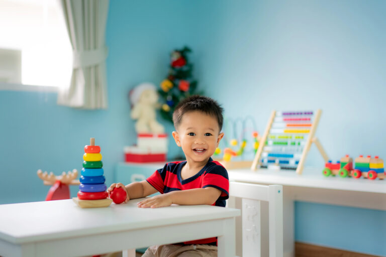 Adorable Asian Toddler baby boy sitting on chair