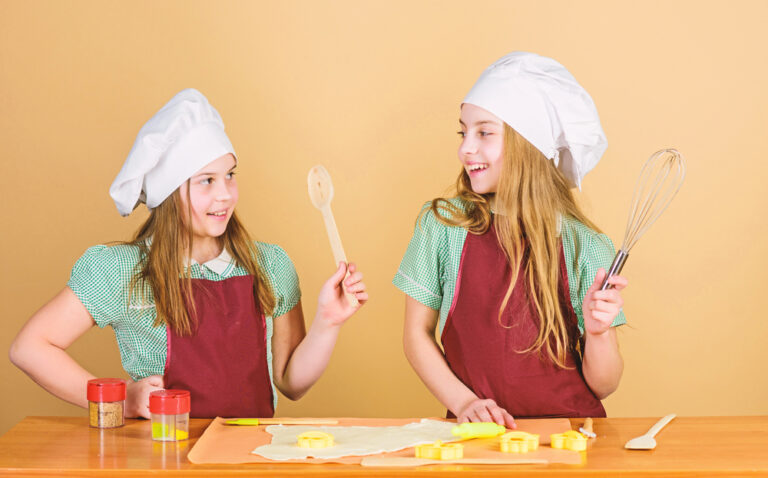 Baking ginger cookies. Tweens sisters having fun